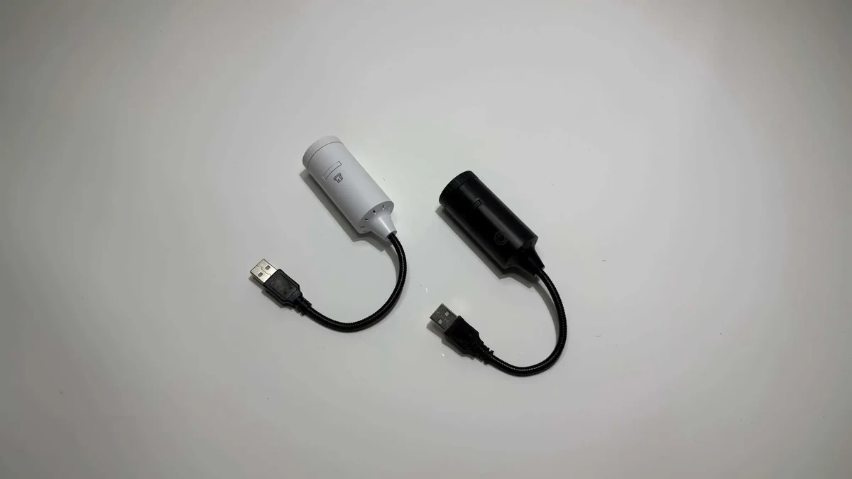 White and black cylindrical projector devices.